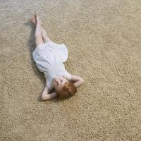 Girl laying on carpet