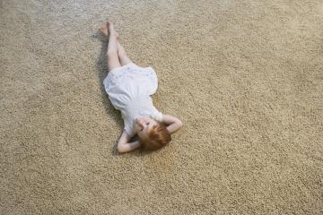 Girl laying on carpet